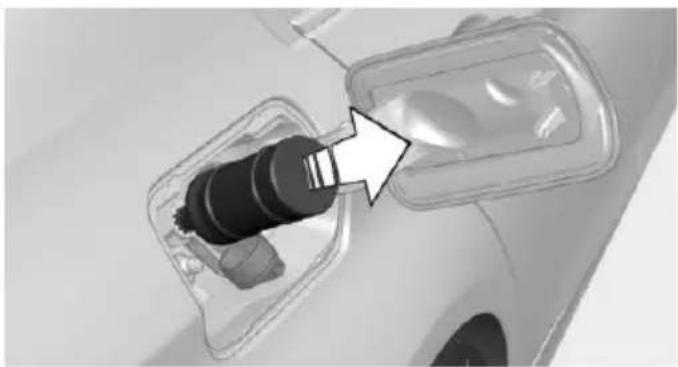 Close-up of a car charging plug with a black connector inserted, showing internal components and a white arrow pointing to the plug (no text or symbols visible)