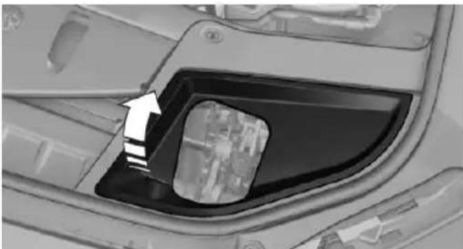Close-up of a car's front compartment showing the door and window, with an arrow pointing to a specific area (no text or symbols visible)