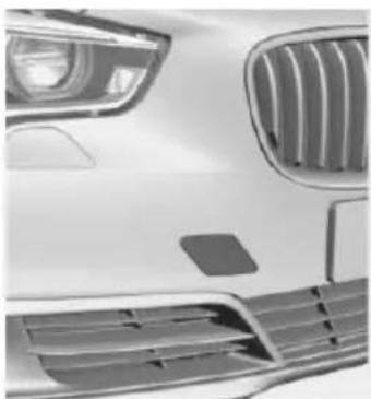 Front view of a white car's grille and headlights (no visible text or symbols)