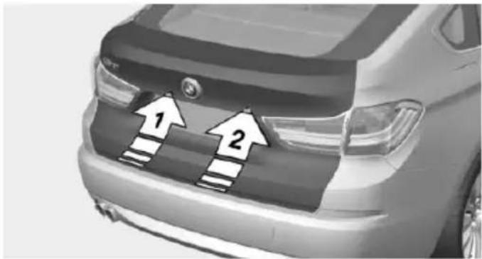Front view of a car with two white arrows pointing up on the grille (no text or symbols visible)