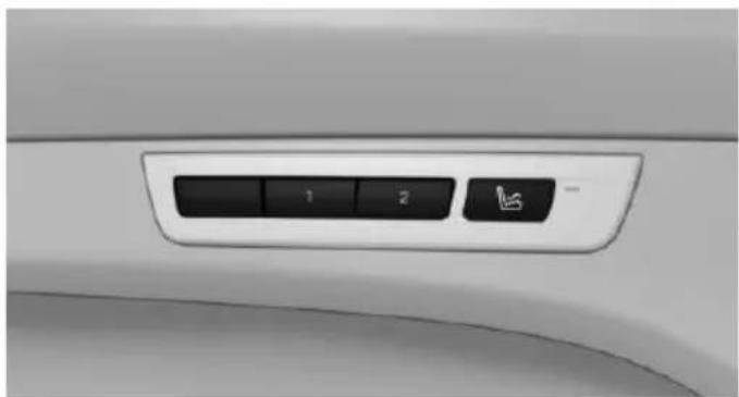 Close-up of a car's side panel with a black control knob and a small directional icon (no text or symbols visible)