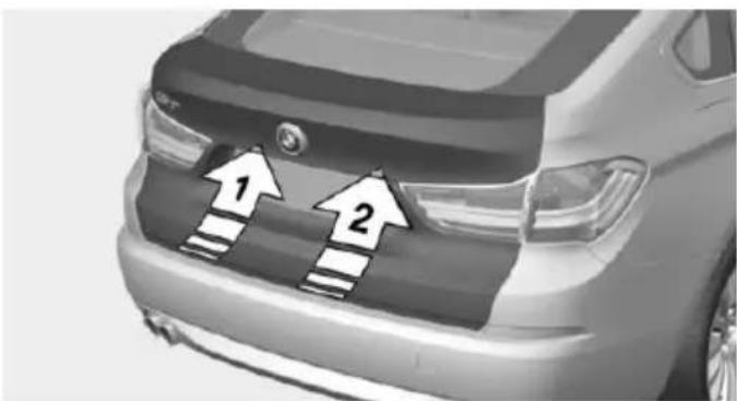 Front view of a car with two white arrows pointing up on the grille (no text or symbols visible)