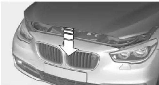 Front view of a silver car head with grille and headlights, showing a white arrow pointing to the grille (no text or symbols visible)