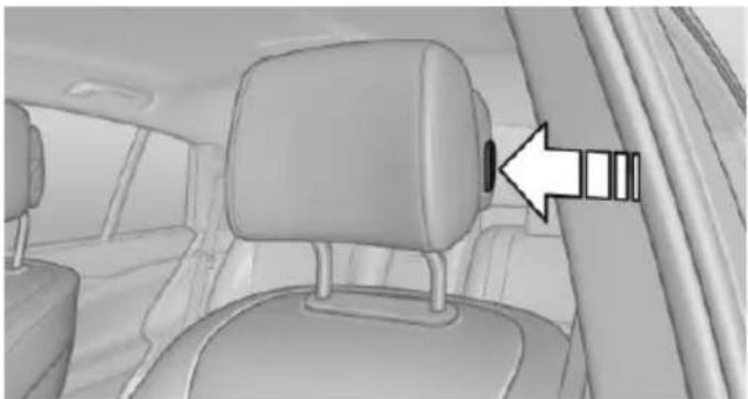 Interior view of a car showing the seatbelt and side panel, with an arrow pointing to the belt (no text or symbols present)