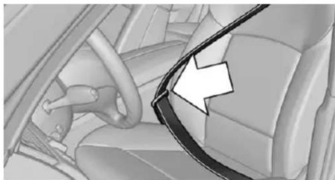 Interior view of a car showing the steering wheel and dashboard area with an arrow pointing to it (no text or symbols present)