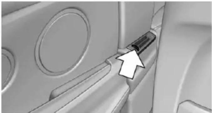 Close-up of a mechanical component with circular features and a black arrow pointing to a specific part (no text or symbols visible)