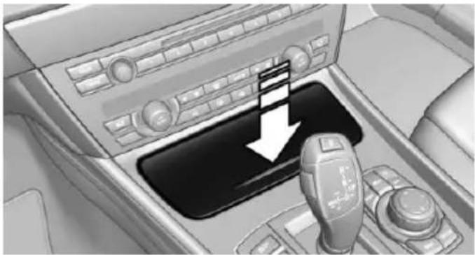 Interior view of a car dashboard with a handset and control panel (no visible text or symbols)