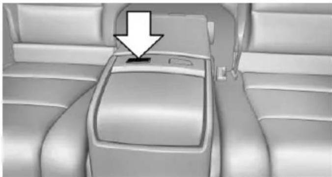 Interior view of a car dashboard with a white arrow pointing to the top panel (no text or symbols visible)