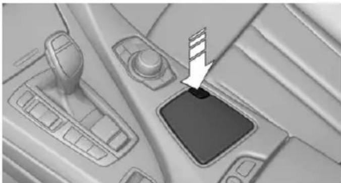 Interior view of a car dashboard with a switch and gear shift (no text or symbols visible)