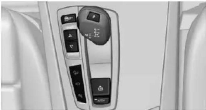 Interior view of a car's side panel showing control buttons and navigation keys (no readable text or symbols)