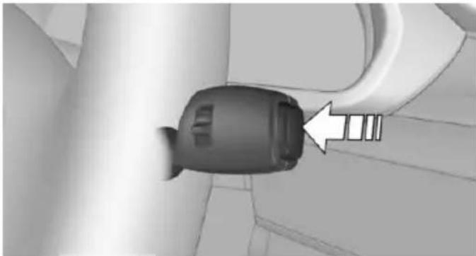 Close-up of a car seatbelt buckle with a white arrow pointing to the seat (no text or symbols visible)