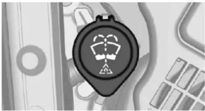 Close-up of a black circular device with a white warning symbol on its face, surrounded by abstract geometric patterns (no readable text or symbols)