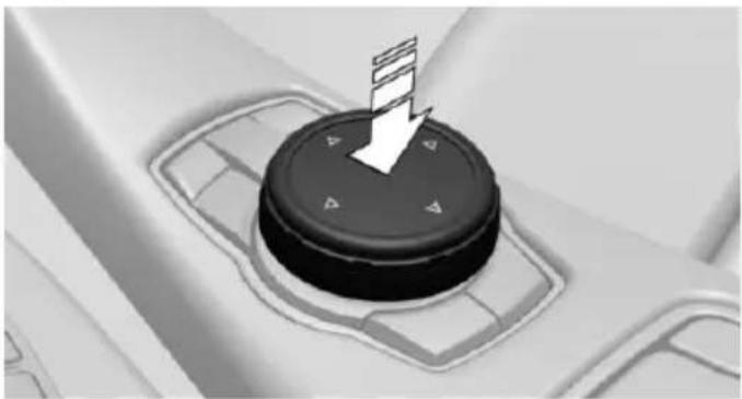 Close-up of a black circular device with directional arrows and control buttons, no visible text or symbols.