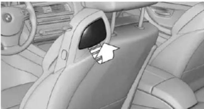 Interior view of a car showing the backrest door and seat area, with no visible text or symbols.