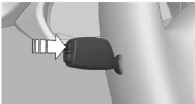 Close-up of a black plug inserted into a cable, with an arrow pointing to the plug (no text or symbols visible)