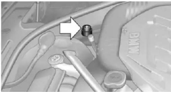 Close-up of a car engine bay with a mounted sensor and valve (no visible text or symbols)