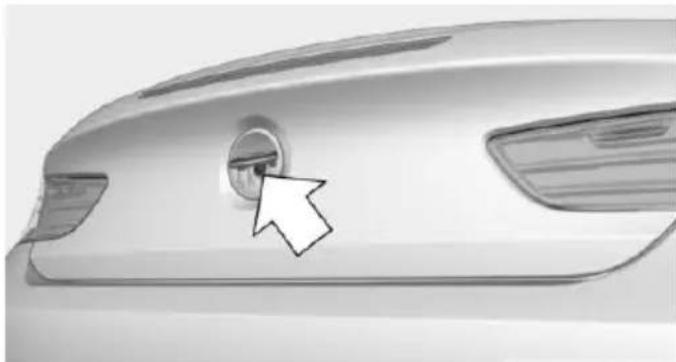 Close-up of a car's rear bumper with a white arrow pointing to the center (no text or symbols visible)