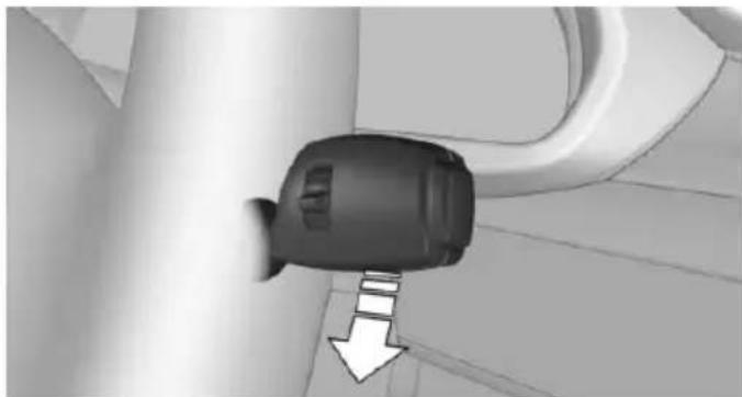 Close-up of a black mechanical component with a downward arrow indicating a step, no visible text or symbols