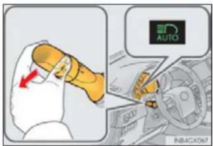 Diagram showing a hand holding a yellow object with a red arrow, alongside an inset image of a car dashboard with an 'AUTO' logo and text 'INB4CX067'.