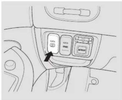 Diagram of a vehicle interior showing control panel with buttons and an arrow pointing to the mode button