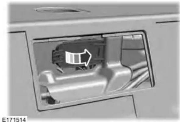 Interior view of a vehicle showing a mechanical component with an arrow indicating direction (no text or symbols)