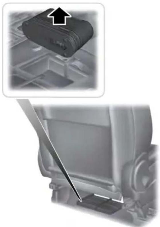 Close-up of a car seatbelt component with an arrow pointing to it, showing no text or symbols.