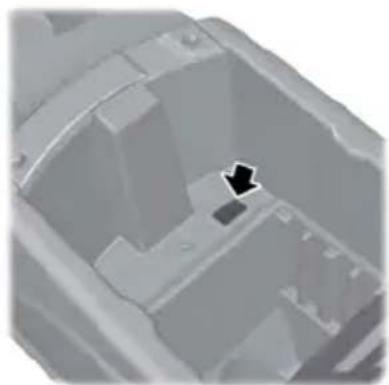 Close-up of a mechanical component with a black arrow pointing to a specific feature (no text or symbols visible)