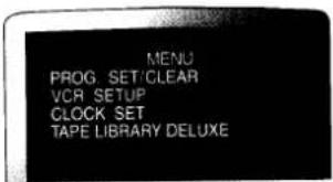MENU PROG SET/CLEAR VCR SETUP CLOCK SET TAPE LIBRARY DELUXE