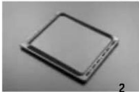 Close-up of a rectangular electronic component with a dark top and metallic edges, labeled '2' in the corner (no other text or symbols visible)