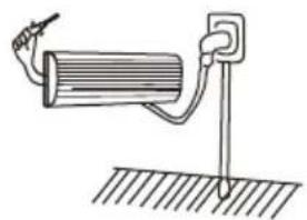 Simple line drawing of a mechanical setup with a cylindrical component and a vertical rod, mounted on a ground surface (no text or symbols)