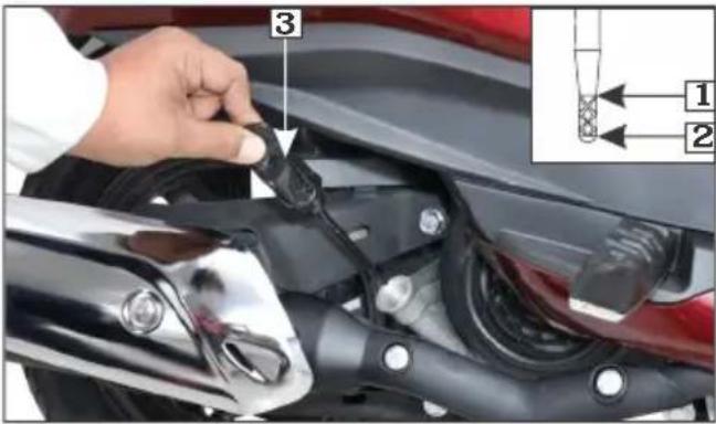 Instructional image showing a hand adjusting a cable component on a motorcycle, with labeled parts and an inset diagram showing two connected components.