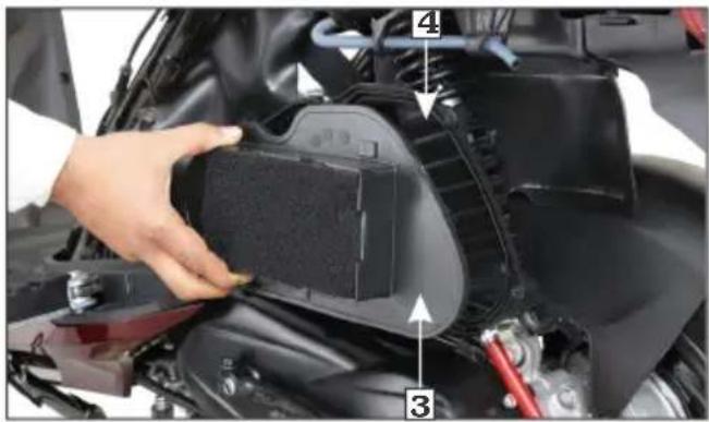 Close-up of a car's engine compartment with numbered annotations indicating parts of the component.