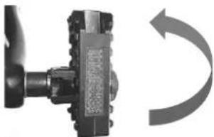 Close-up of a mechanical component with a curved arrow indicating rotational motion (no text or symbols visible)