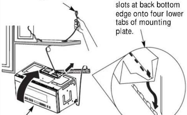 slots at back bottom edge onto four lower tabs of mounting plate.