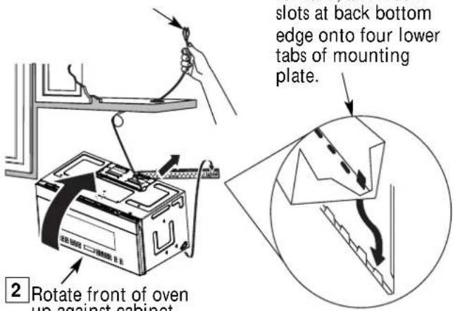 slots at back bottom edge onto four lower tabs of mounting plate. 2 Rotate front of oven up against cabinet
