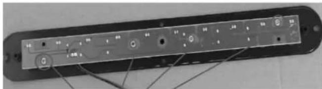 Labeled electronic device panel with buttons and indicator lights, showing internal components and connections