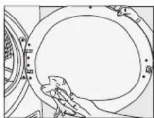 Line drawing of a hand cleaning a circular mechanical component (no text or symbols)