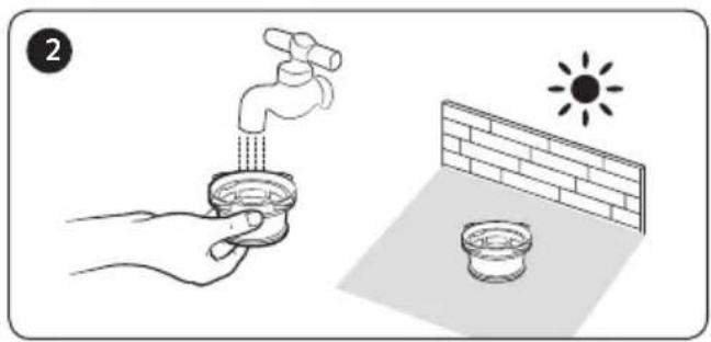 Illustration showing a hand washing a faucet with a sun symbol above its surface, next to a brick wall and a bowl (no text or symbols).