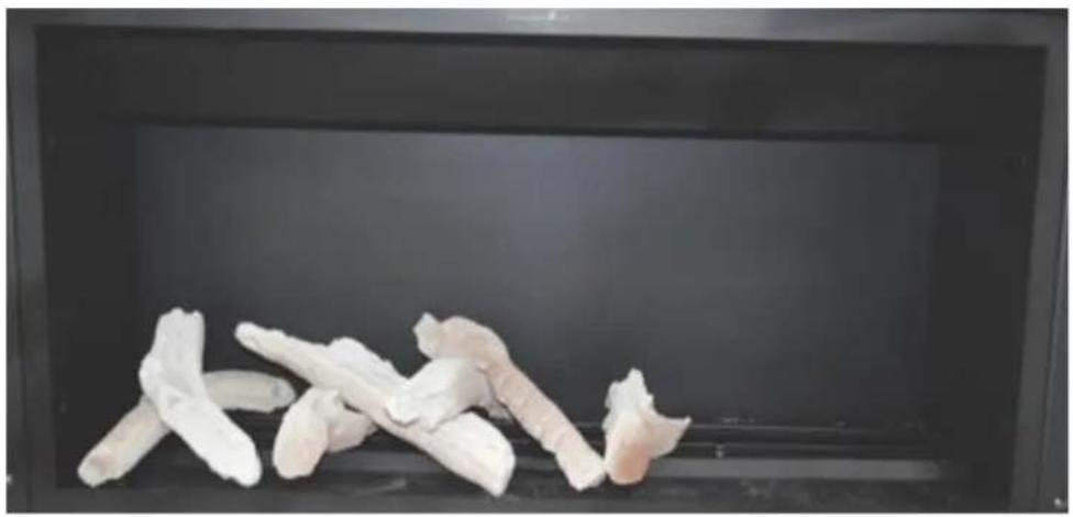 Black tray holding several white, irregularly shaped food items (no text or symbols visible)