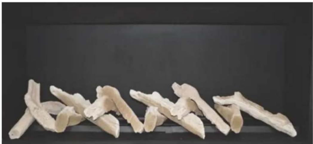 Close-up of dried, sliced white root pieces arranged in a row against a dark background (no text or symbols visible)
