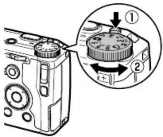 Diagram showing camera mode dial adjustment with numbered callouts highlighting the component and rotation direction