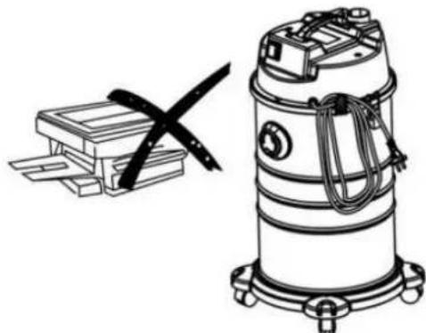 Illustration of a vacuum cleaner with a cross mark symbol, next to a stack of mechanical components (no text or labels present)