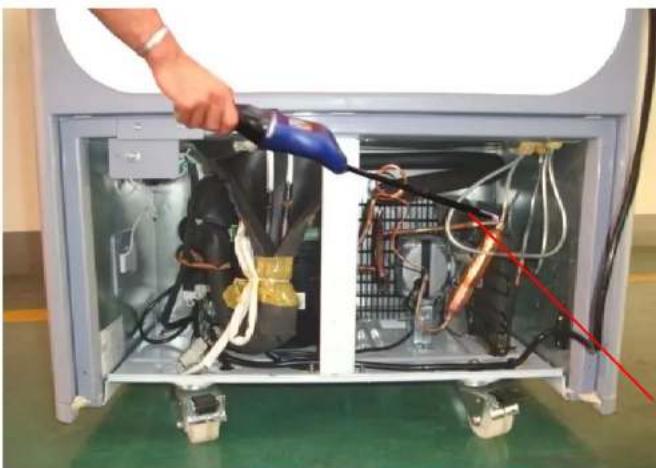 Interior view of an appliance with visible wiring and components, no text or symbols present