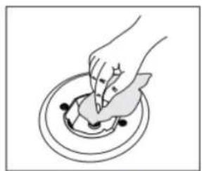 Illustration of a hand pressing down on a circular object with black dots (no text or symbols)