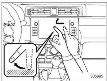 Diagram showing car air condition control panel with hand and tool, including a close-up of the switch mechanism
