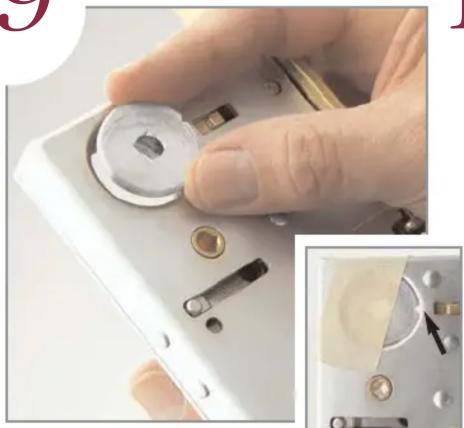 Close-up of a hand holding a small electronic device with a circular dial and multiple switches, alongside an inset showing the close-up of its internal components (no text or symbols visible)