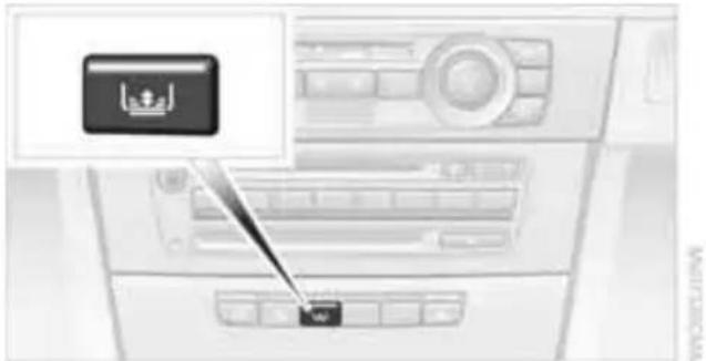 Diagram showing a car air conditioner unit with an Arabic flag icon and a small button labeled 'OK' pointing to the control panel.
