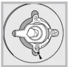 Mechanical component diagram showing a central hub with four surrounding holes and a small arrow pointing to a specific part (no text or symbols present)