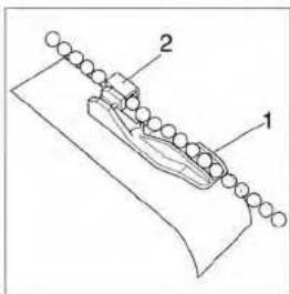 Technical diagram showing a mechanical assembly with labeled parts 1 and 2, likely for assembly or maintenance.
