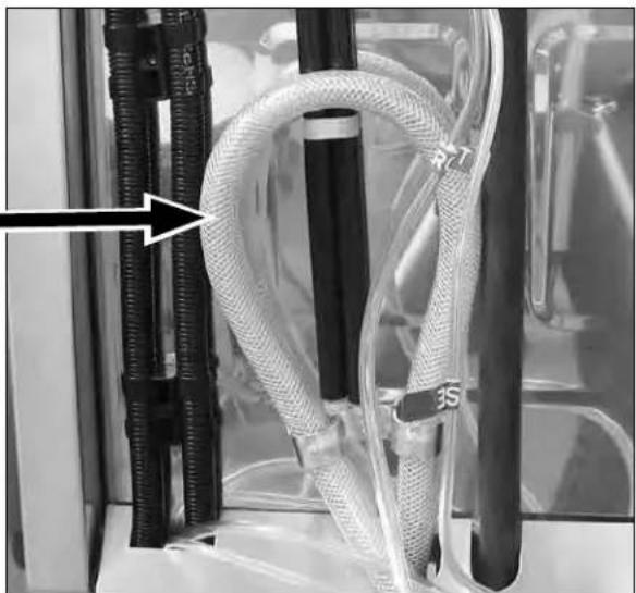 Close-up of a medical or laboratory setup with coiled tubing and connectors, no visible text or symbols